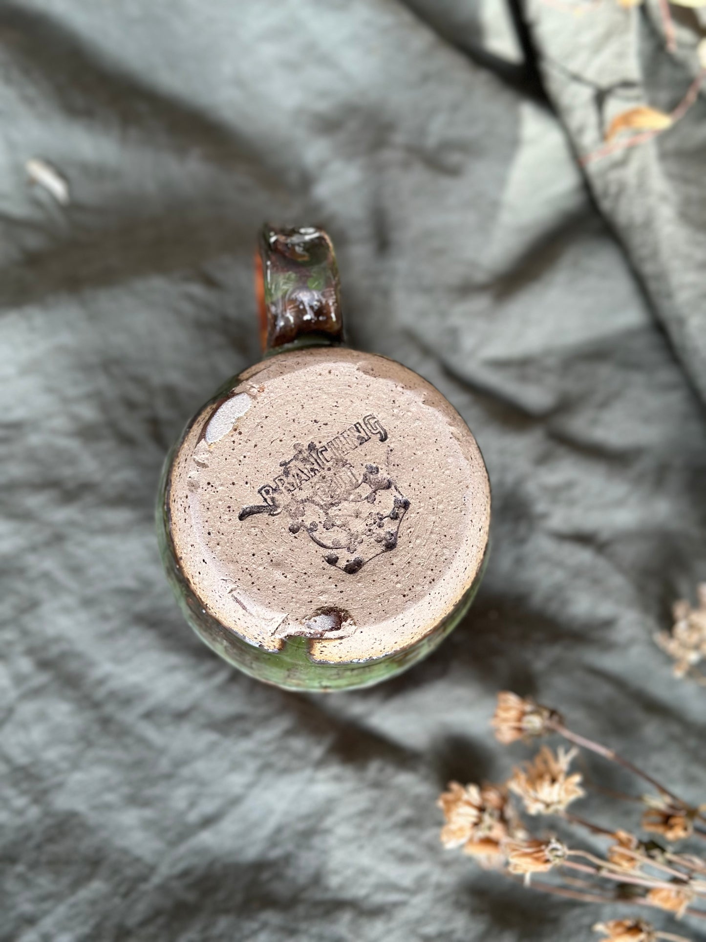 Bottom of flare mug with oatmeal strip in middle