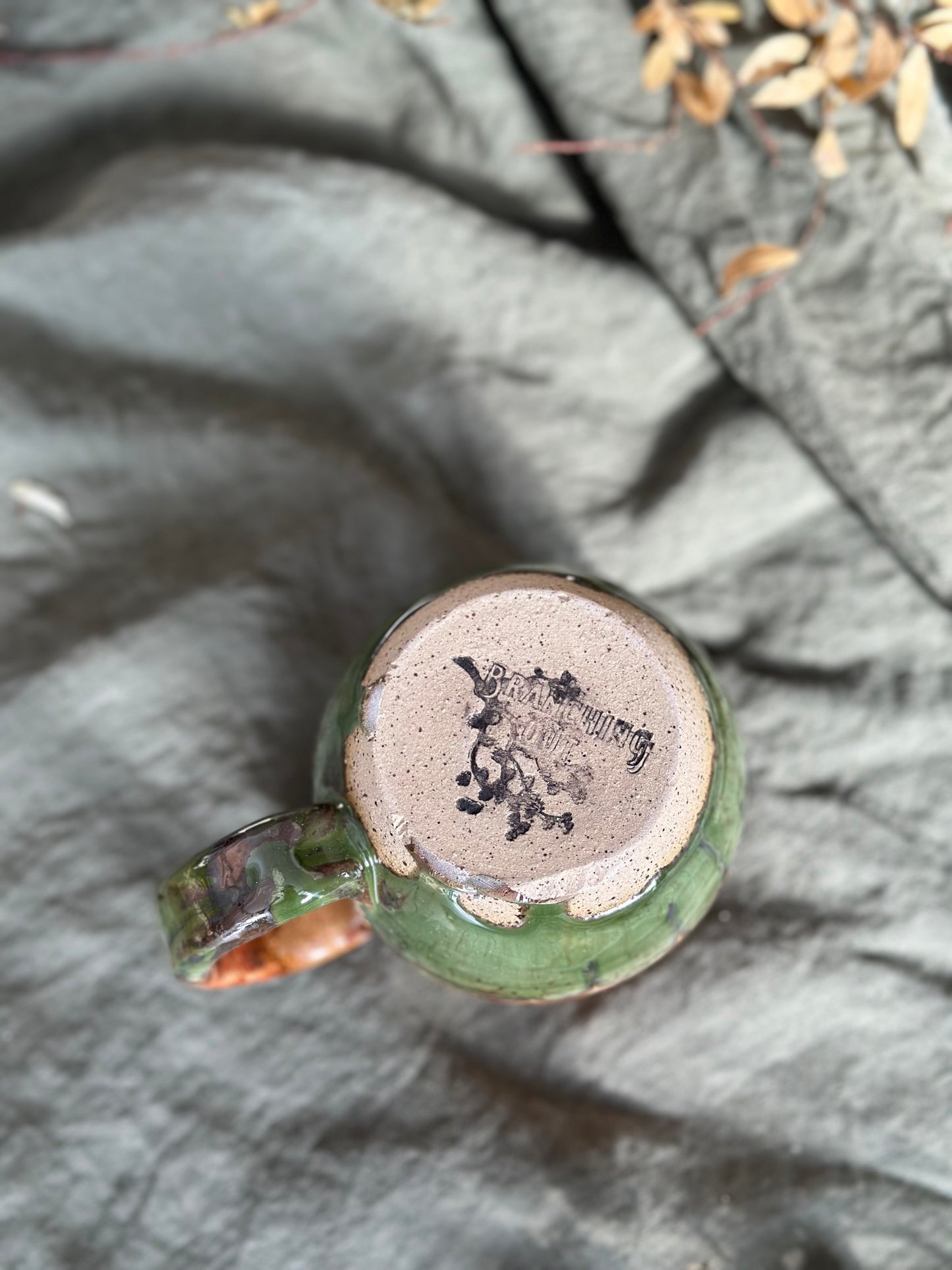 Bottom of no flare - burnt orange/green mug